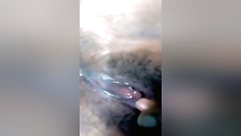 Hairy solo female is fingering hairy pussy on the floor