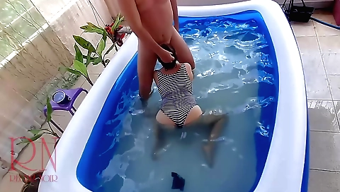 Slutty brunette riding a cock in the pool in the pool