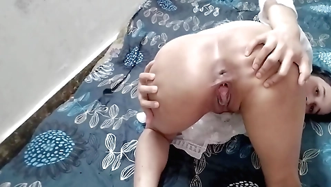Female gets naked on bed and masturbates on her back