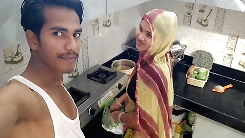 Indian housewife cooks with a pan and gets a delicious curry