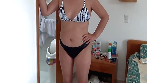 Sexy blonde babe wearing a bikini showing off her legs