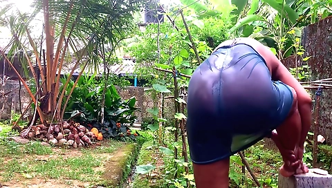 Indian woman in sexy lingerie takes shower outside