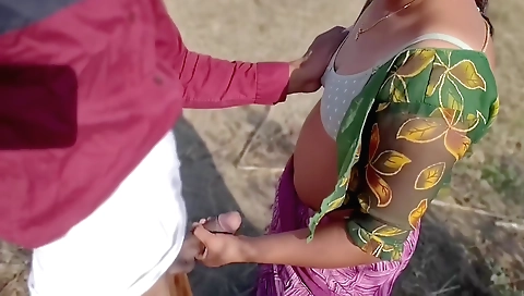 Brunette is doing a hand job and a cunt-hj outdoors