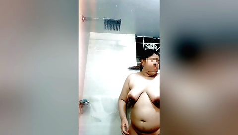 Horny indian brunette in a white bathrobe is in the shower